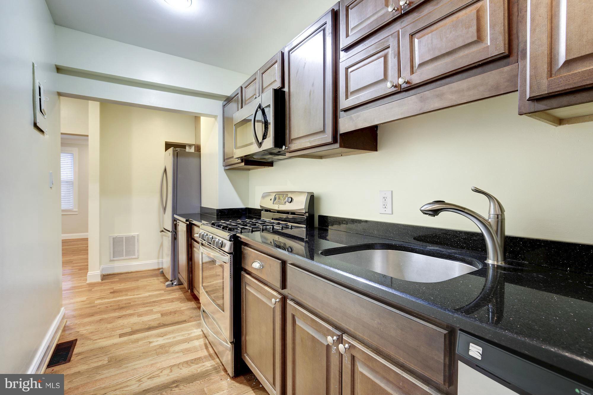 1241 Jackson Street Northeast Washington, DC 20017 - Photo 12 of 30 a kitchen with stainless steel appliances granite countertop a sink and a stove