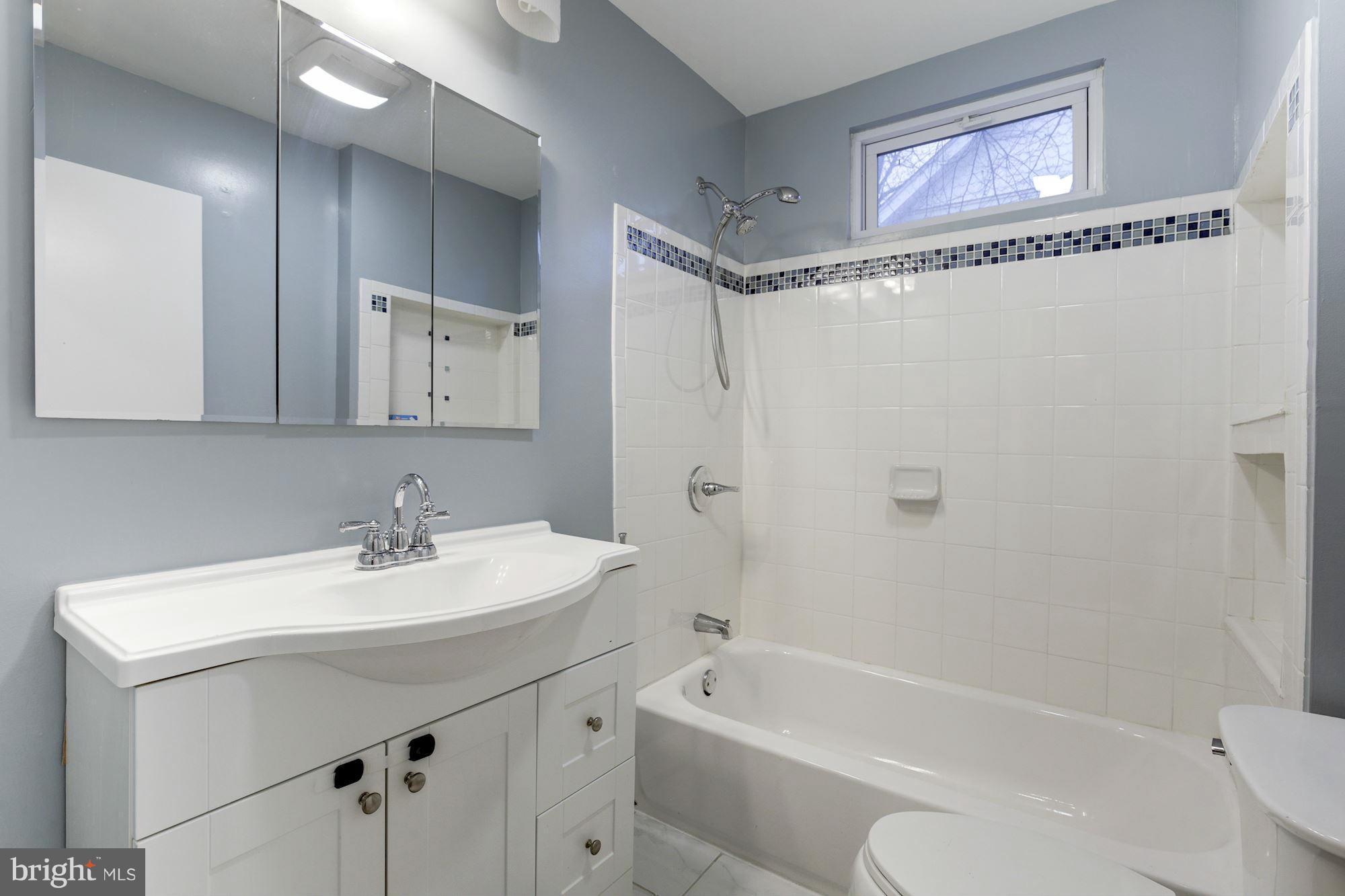 1241 Jackson Street Northeast Washington, DC 20017 - Photo 15 of 30 a bathroom with a sink a toilet and shower