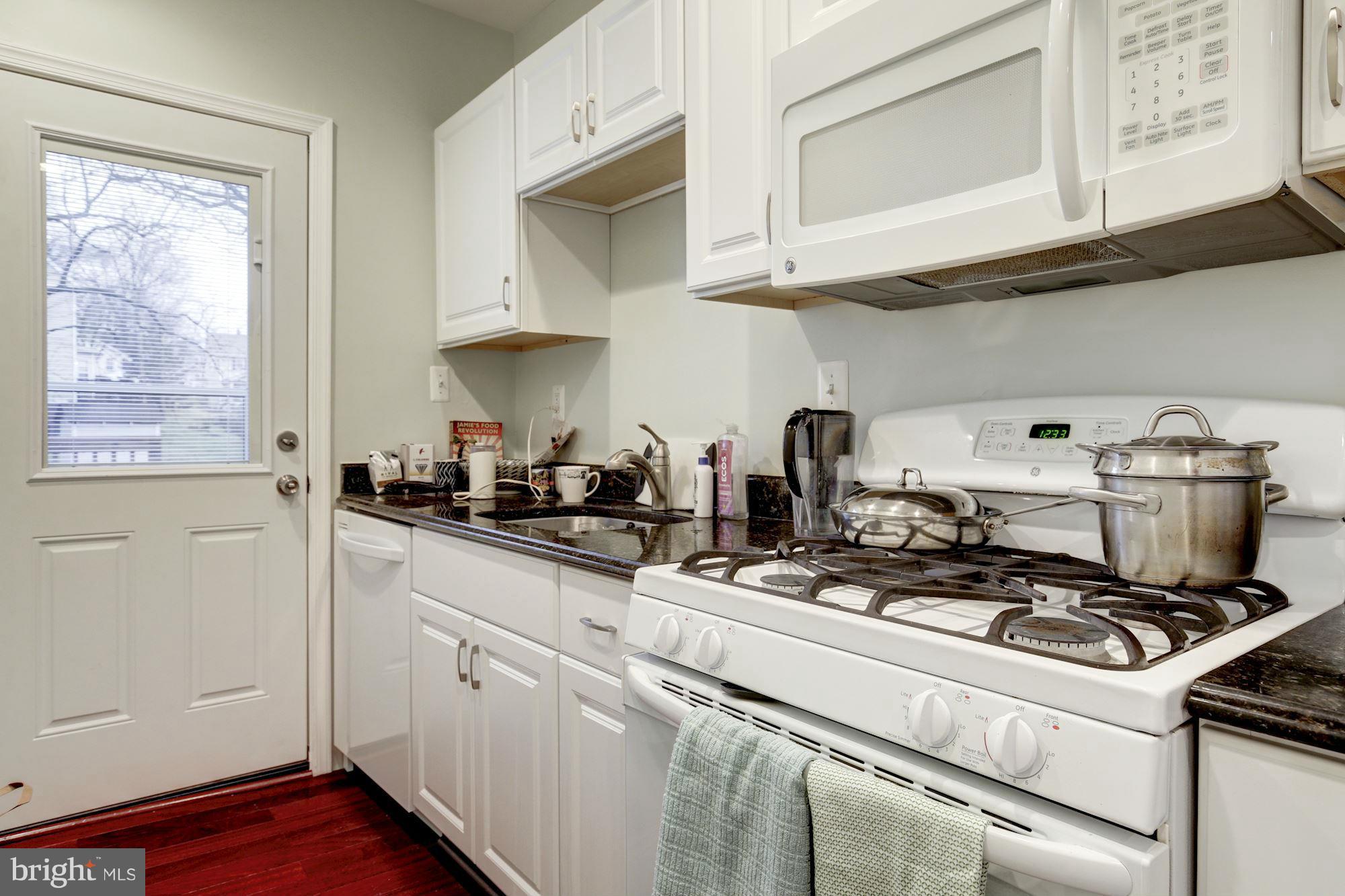 1241 Jackson Street Northeast Washington, DC 20017 - Photo 18 of 30 a kitchen with stainless steel appliances granite countertop white cabinets and a stove