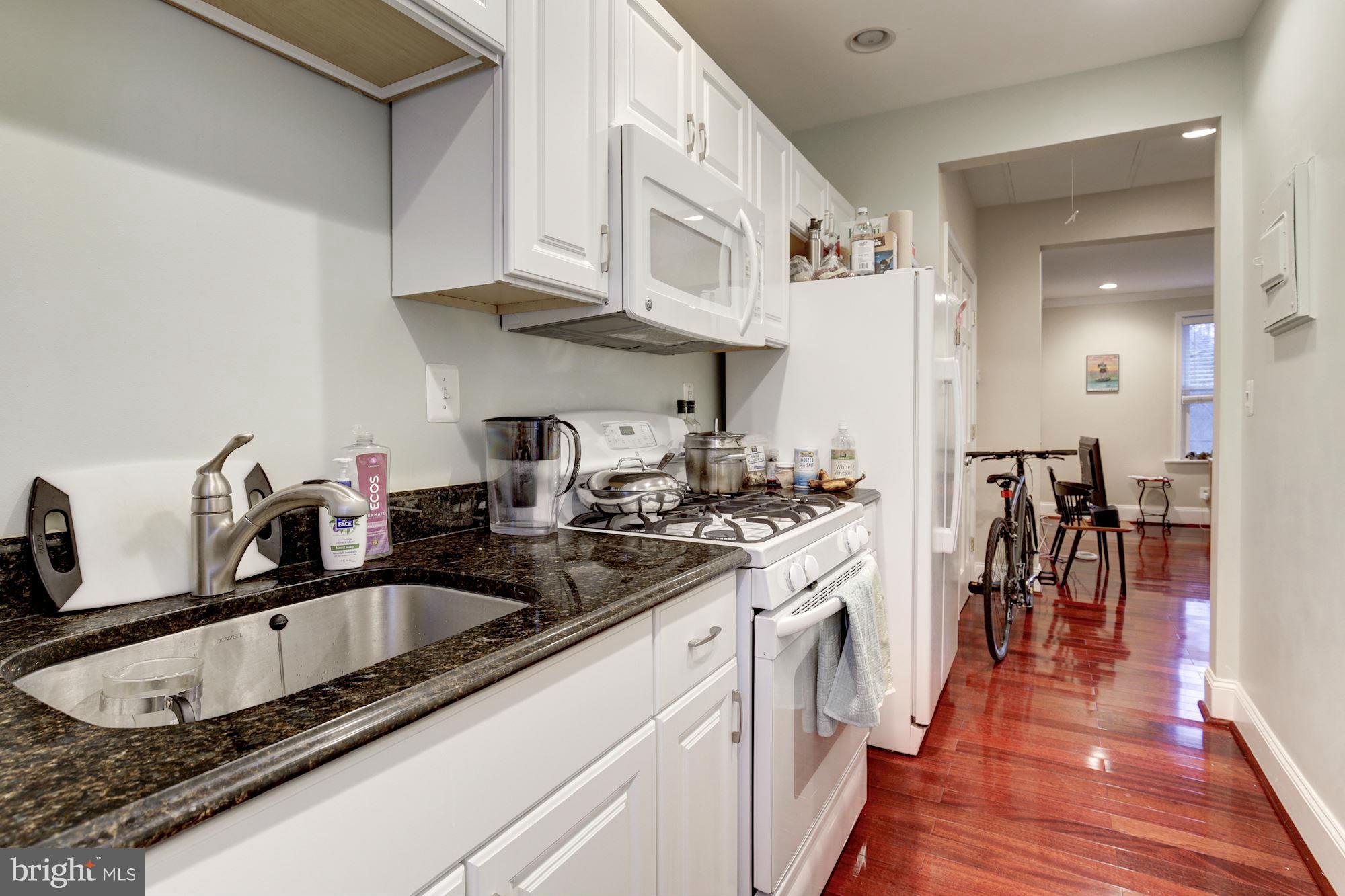 1241 Jackson Street Northeast Washington, DC 20017 - Photo 19 of 30 a kitchen with stainless steel appliances granite countertop a sink a stove and cabinets