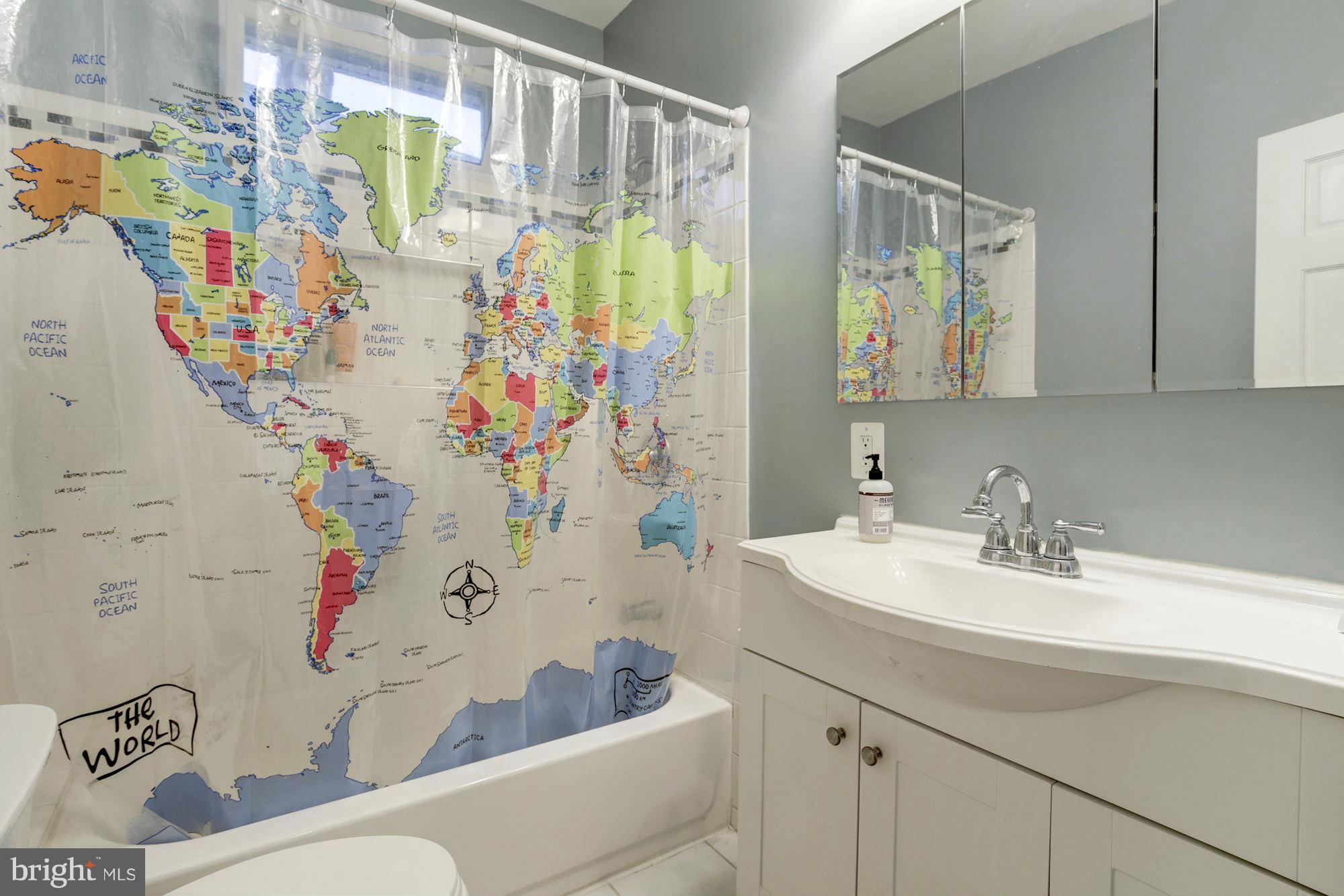 1241 Jackson Street Northeast Washington, DC 20017 - Photo 21 of 30 a bathroom with a sink a mirror and shower curtain