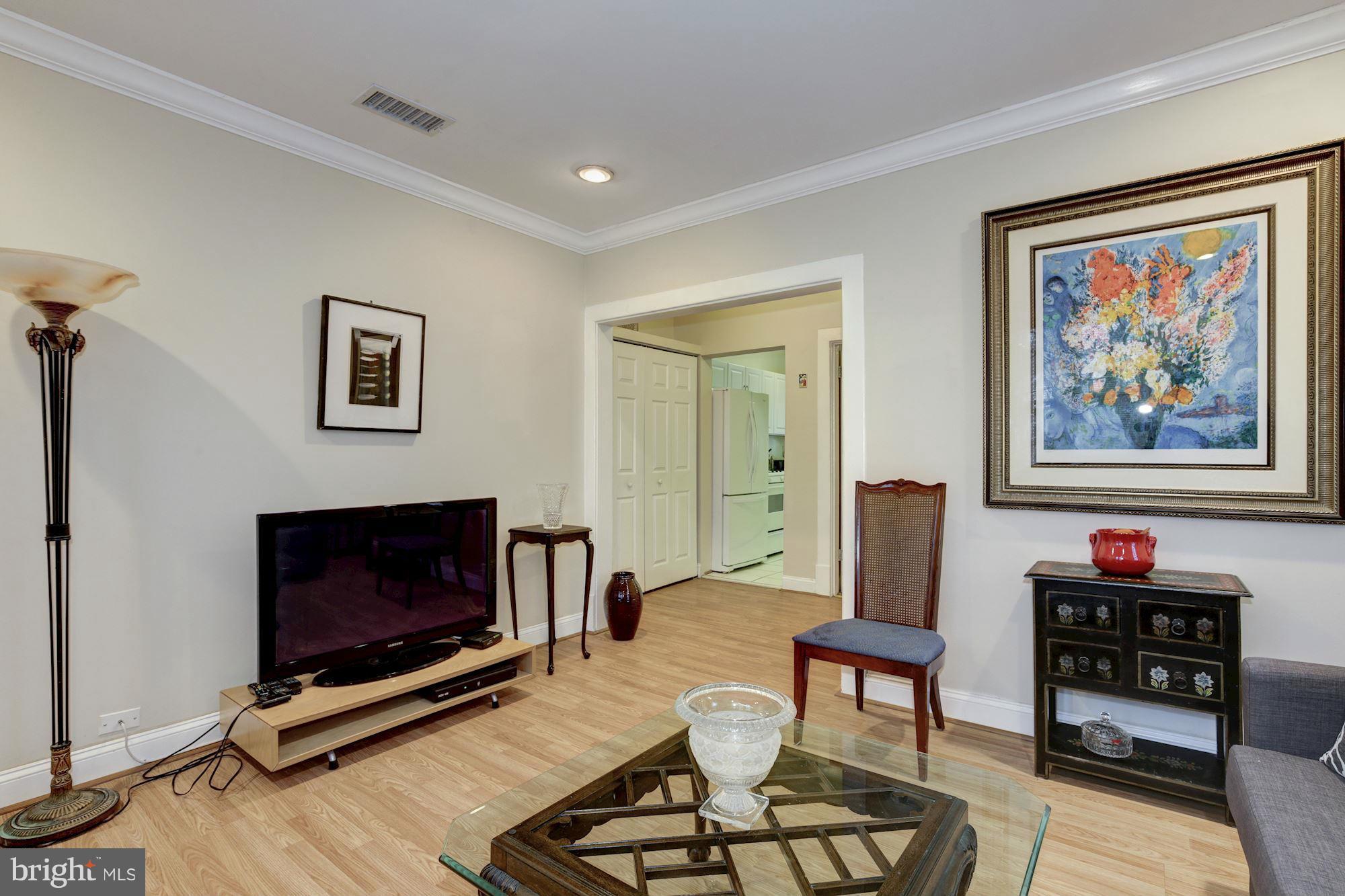 1241 Jackson Street Northeast Washington, DC 20017 - Photo 23 of 30 a living room with furniture a flat screen tv and a fireplace