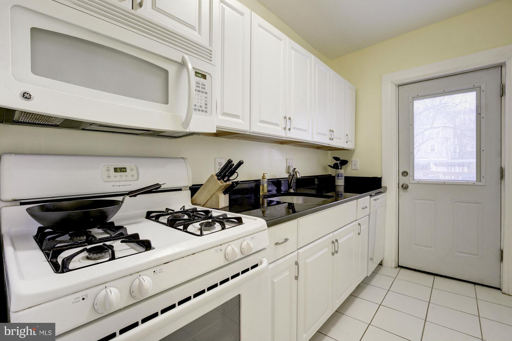 1241 Jackson Street Northeast Washington, DC 20017 - Photo 24 of 30 a kitchen with white cabinets and appliances