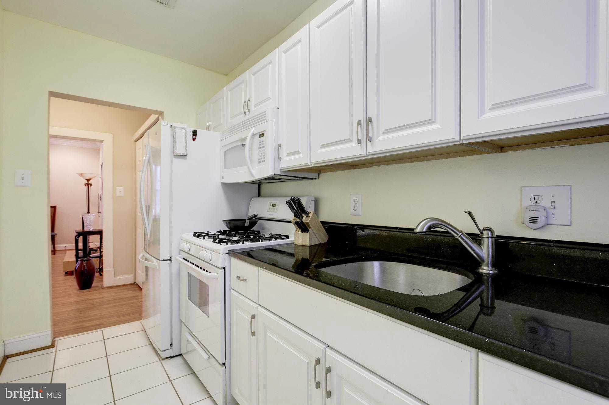 1241 Jackson Street Northeast Washington, DC 20017 - Photo 25 of 30 a kitchen with stainless steel appliances granite countertop a sink stove and cabinets
