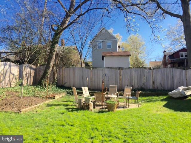1241 Jackson Street Northeast Washington, DC 20017 - Photo 30 of 30 a view of backyard with table and chairs and wooden fence