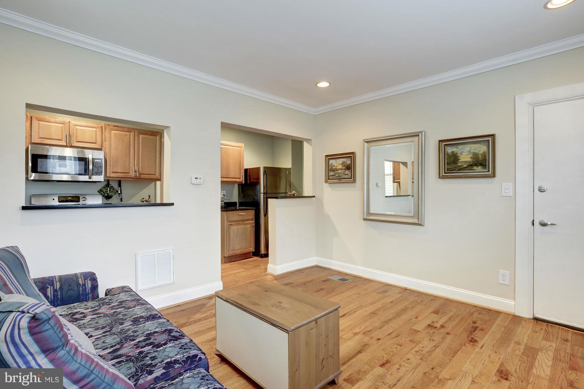 1241 Jackson Street Northeast Washington, DC 20017 - Photo 4 of 30 a living room with a couch and a window
