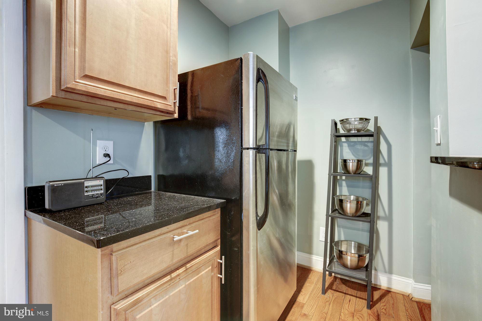 1241 Jackson Street Northeast Washington, DC 20017 - Photo 5 of 30 a kitchen with stainless steel appliances granite countertop a refrigerator and a sink