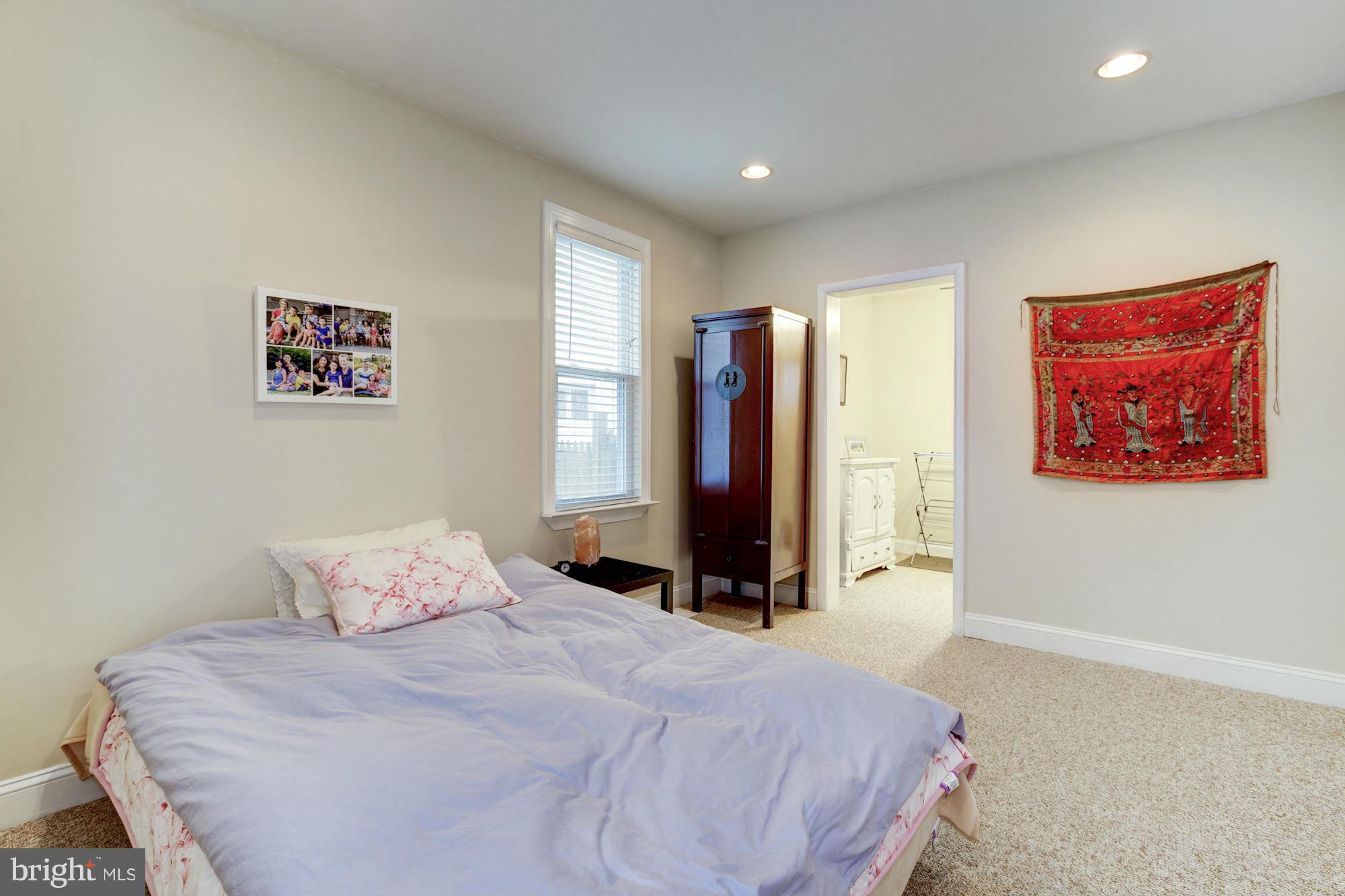 1241 Jackson Street Northeast Washington, DC 20017 - Photo 7 of 30 a bedroom with a bed and a large mirror