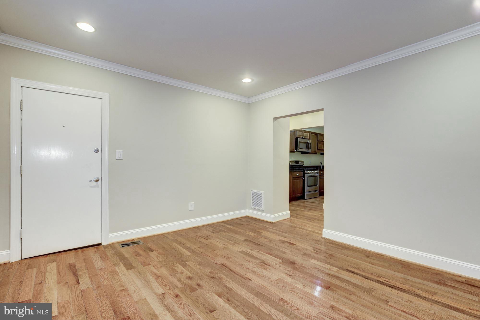 1241 Jackson Street Northeast Washington, DC 20017 - Photo 9 of 30 a view of an empty room with wooden floor and closet