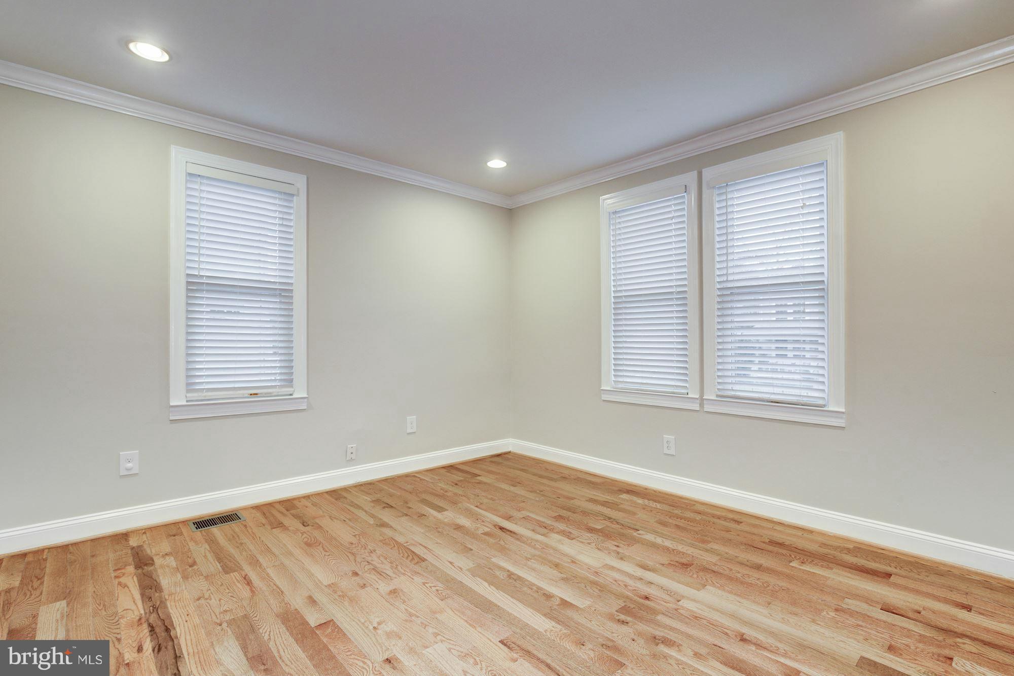 1241 Jackson Street Northeast Washington, DC 20017 - Photo 10 of 30 a view of empty room with wooden floor and fan