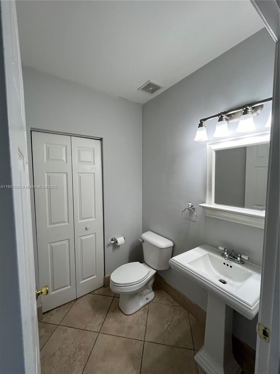 4790 Southwest 165th Avenue Miramar, FL 33027 - Photo 11 of 31 a bathroom with a toilet sink and mirror
