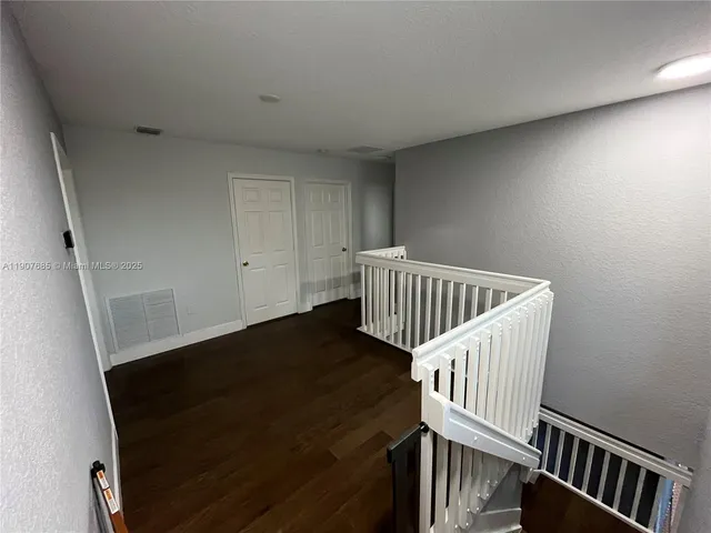 a view of room with stairs and windows