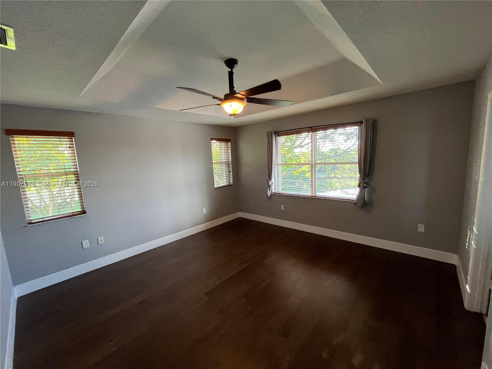 4790 Southwest 165th Avenue Miramar, FL 33027 - Photo 15 of 31 a view of an empty room with wooden floor and a window