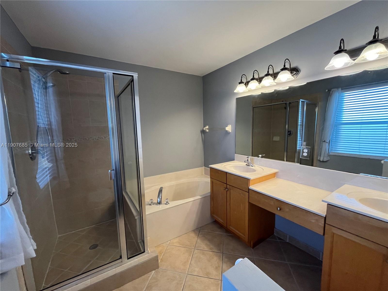 4790 Southwest 165th Avenue Miramar, FL 33027 - Photo 18 of 31 a bathroom with a tub sink and mirror