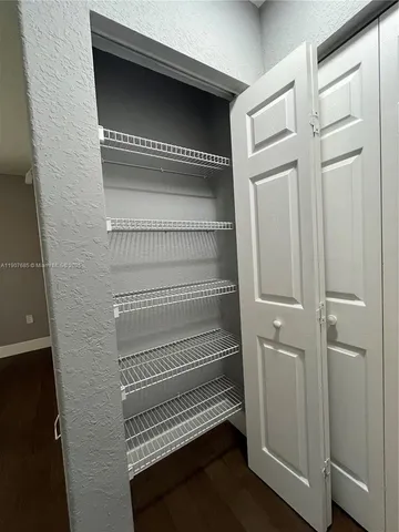 a view of storage and utility room with racks on the wall