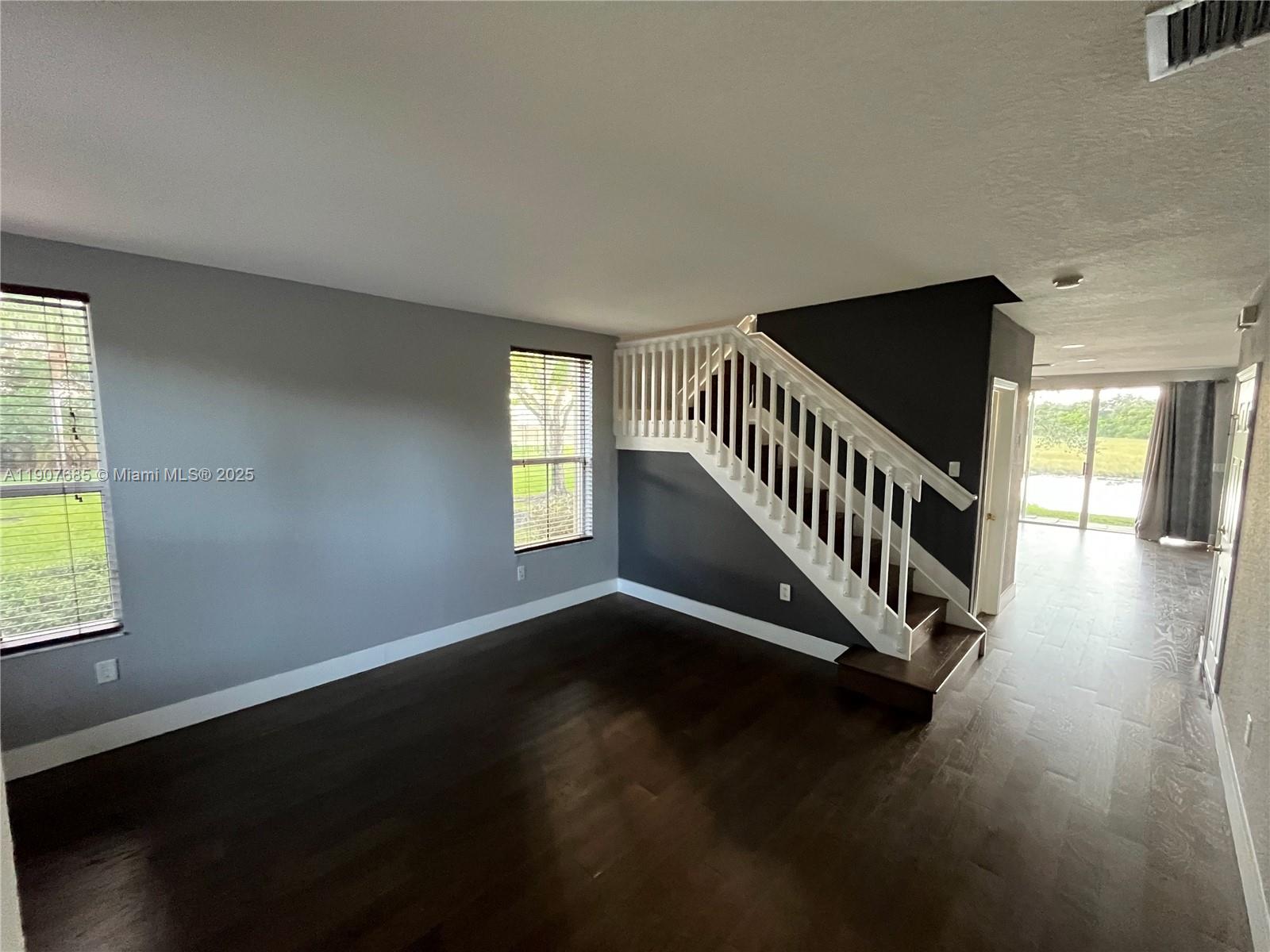 4790 Southwest 165th Avenue Miramar, FL 33027 - Photo 2 of 31 a view of an empty room with wooden floor and a window