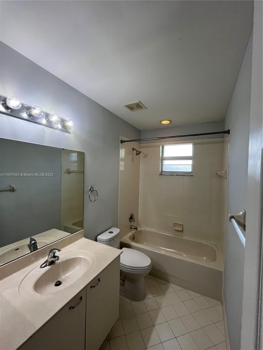 4790 Southwest 165th Avenue Miramar, FL 33027 - Photo 26 of 31 a bathroom with a double vanity sink toilet mirror and bathtub