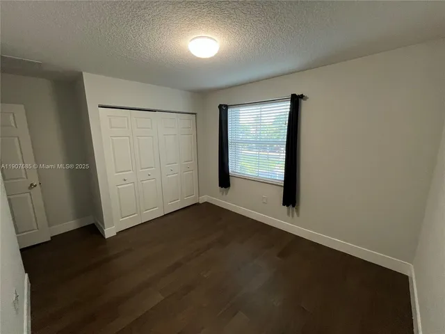 an empty room with wooden floor