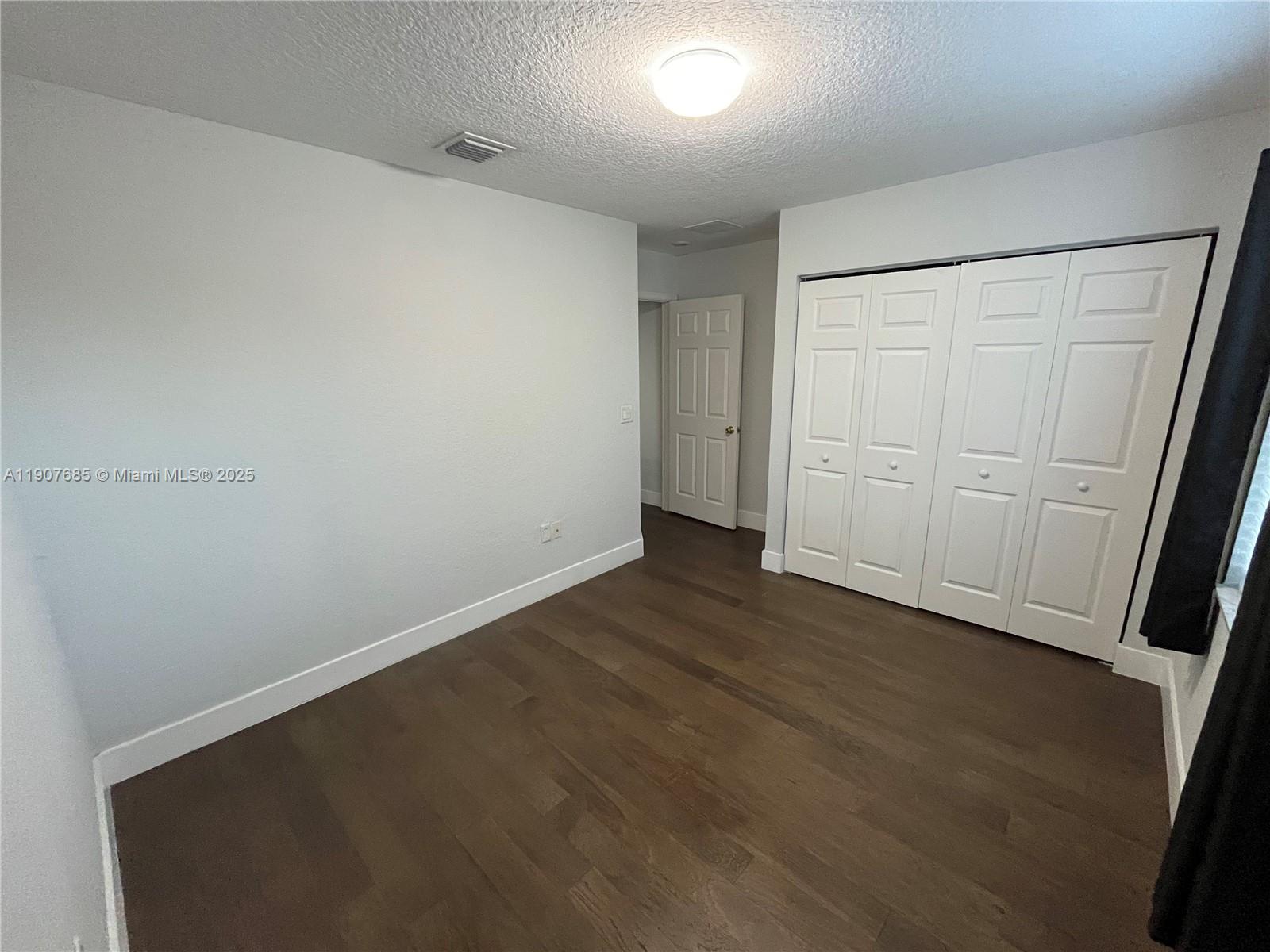 4790 Southwest 165th Avenue Miramar, FL 33027 - Photo 29 of 31 an empty room with wooden floor