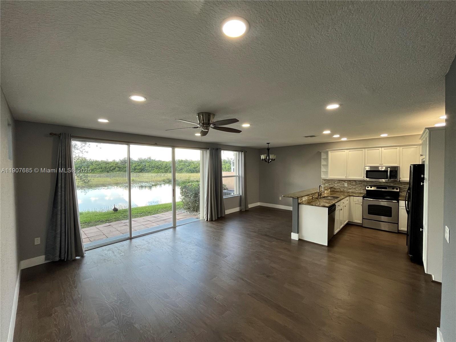 4790 Southwest 165th Avenue Miramar, FL 33027 - Photo 8 of 31 an empty room with wooden floor and windows