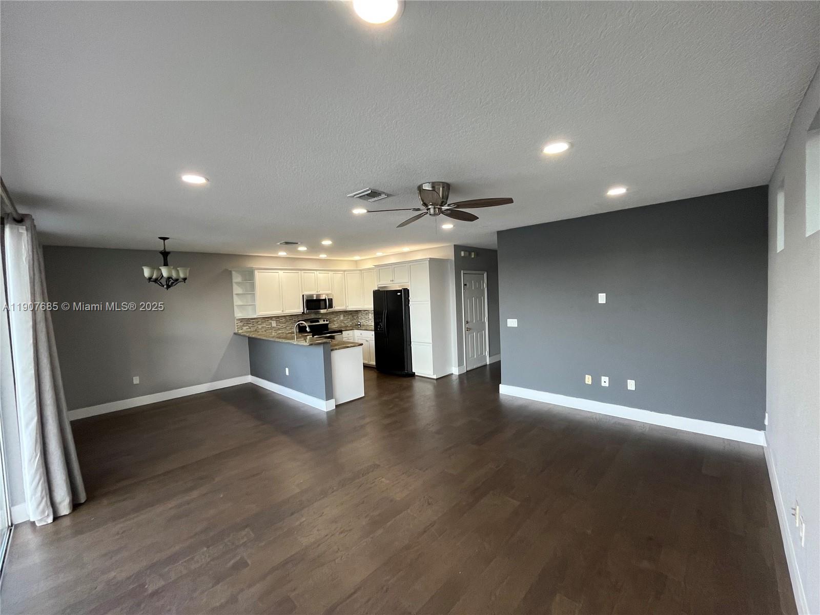 4790 Southwest 165th Avenue Miramar, FL 33027 - Photo 9 of 31 a view of a living room a kitchen and a sink