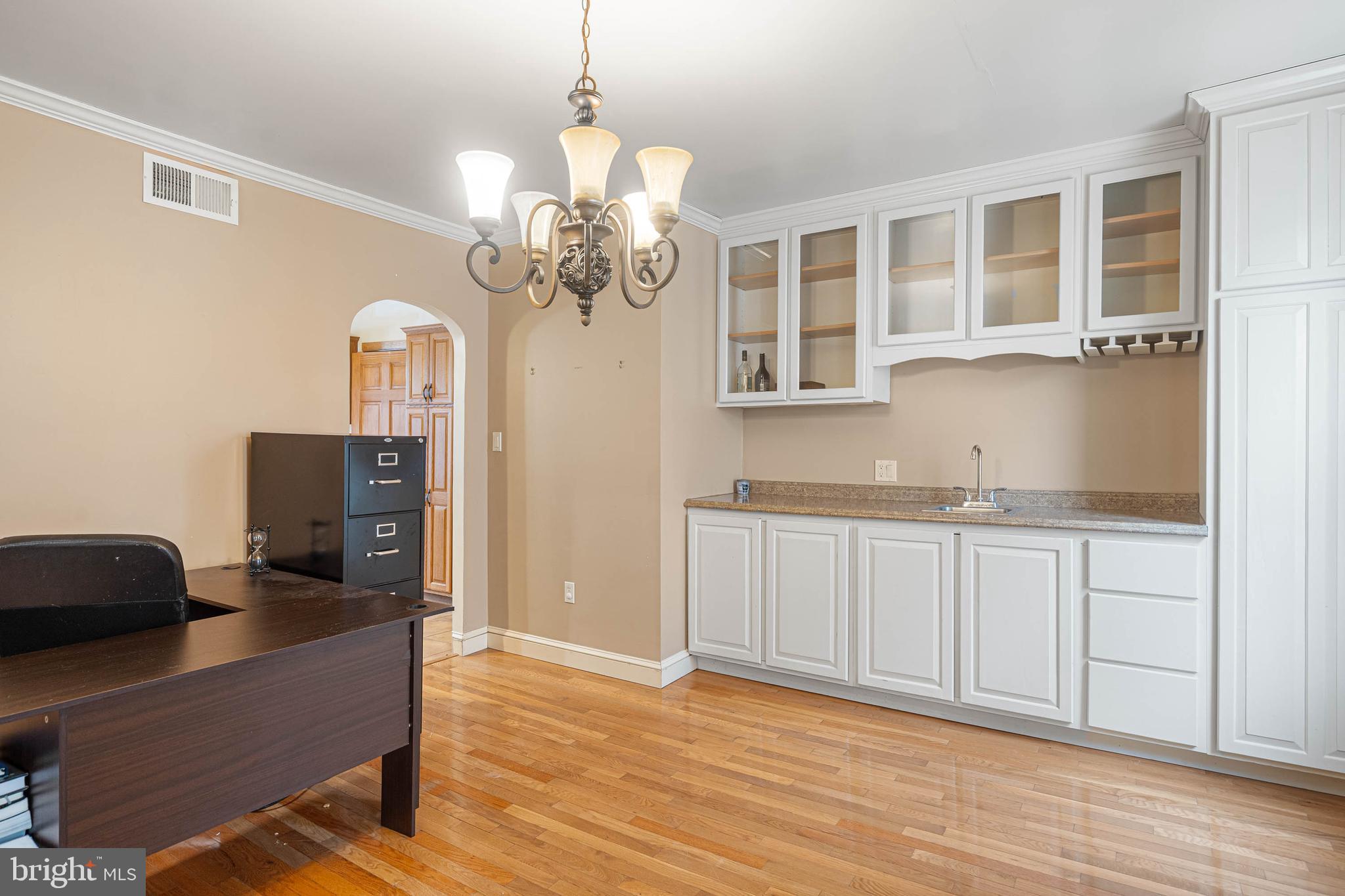 412 East State Street Delmar, MD 21875 - Photo 15 of 36 a living room with granite countertop furniture and a chandelier