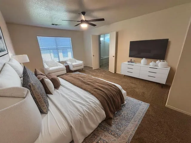 a bedroom with a bed and a flat screen tv