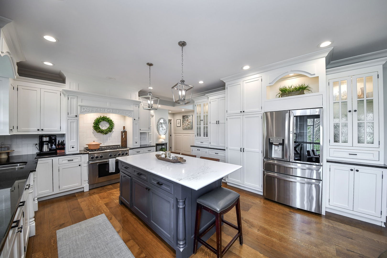 75 Hawkins Circle Wheaton, IL 60189 - Photo 11 of 45 a large kitchen with stainless steel appliances granite countertop a stove a sink a refrigerator and a dining table with chairs