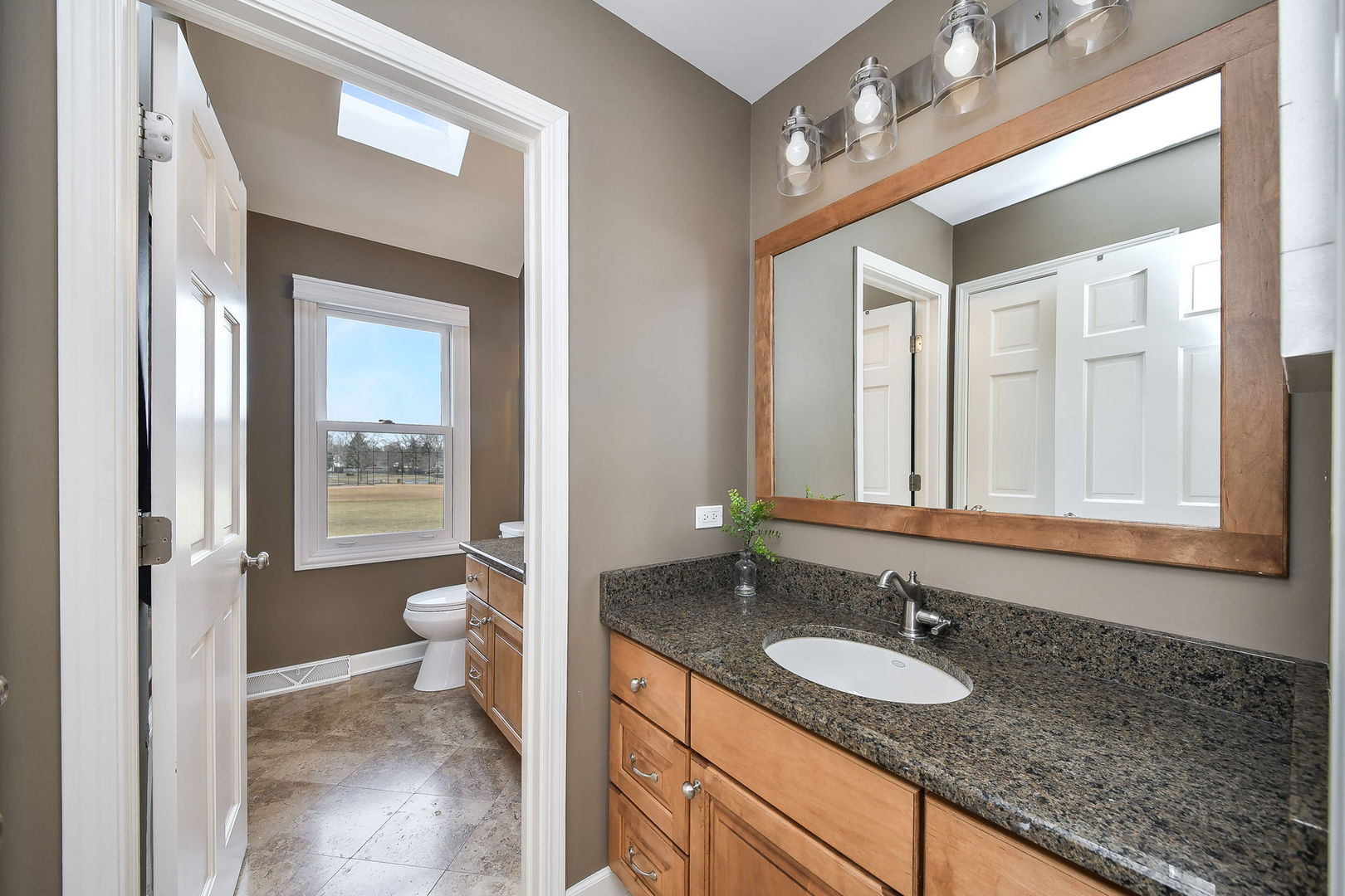 75 Hawkins Circle Wheaton, IL 60189 - Photo 29 of 45 a bathroom with a granite countertop sink and a mirror