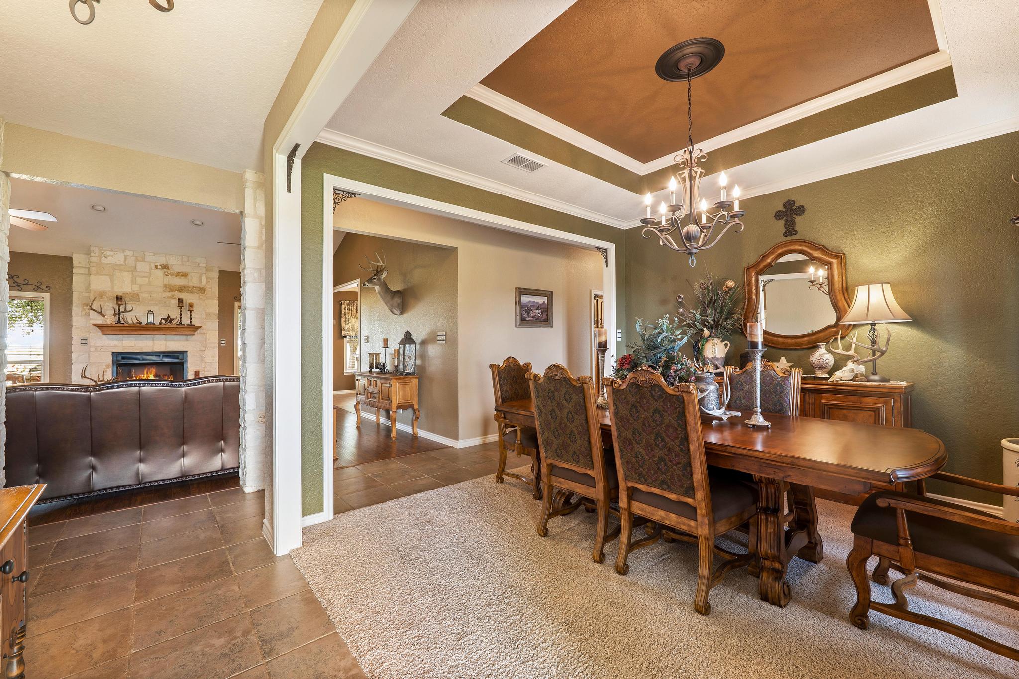 19000 Farm To Market Road 971 Granger, TX 76530 - Photo 8 of 40 The formal dining room is crowned by an elegant tray ceiling and a timeless chandelier.