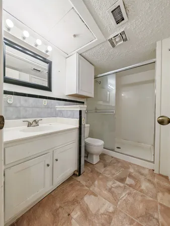 a bathroom with a sink toilet and shower