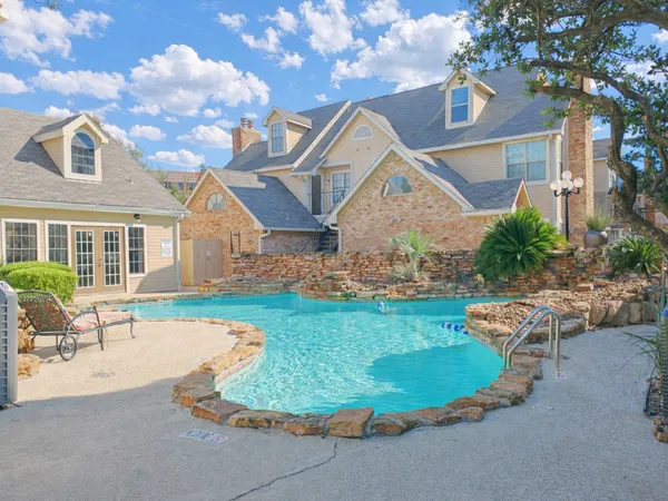a view of a house with swimming pool and sitting area