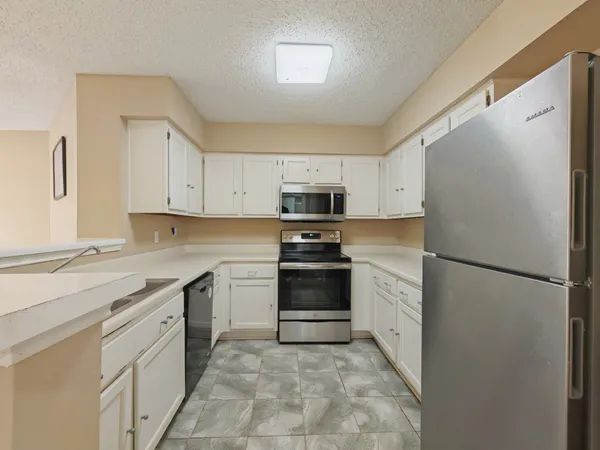 a kitchen with a refrigerator stove and sink