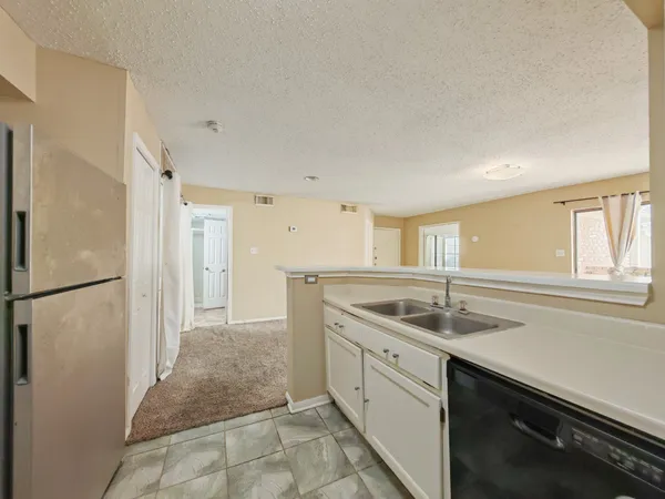 a kitchen with a sink and refrigerator