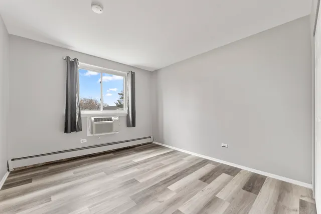 a view of wooden floor and window in a room