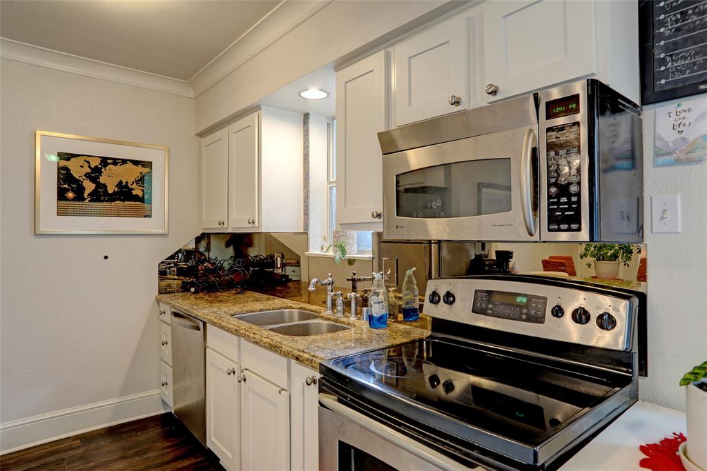 7736 Meadow Road, Unit 102 Dallas, TX 75230 - Photo 11 of 25 a kitchen with stainless steel appliances a stove a sink and a microwave
