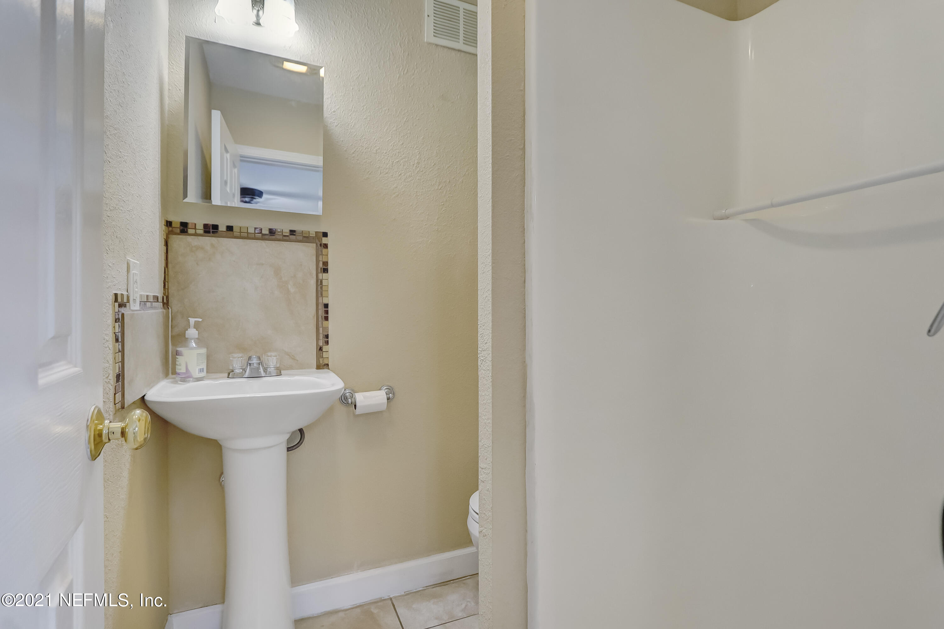 5207 Sunderland Road Jacksonville, FL 32210 - Photo 11 of 23 a bathroom with a sink and mirror