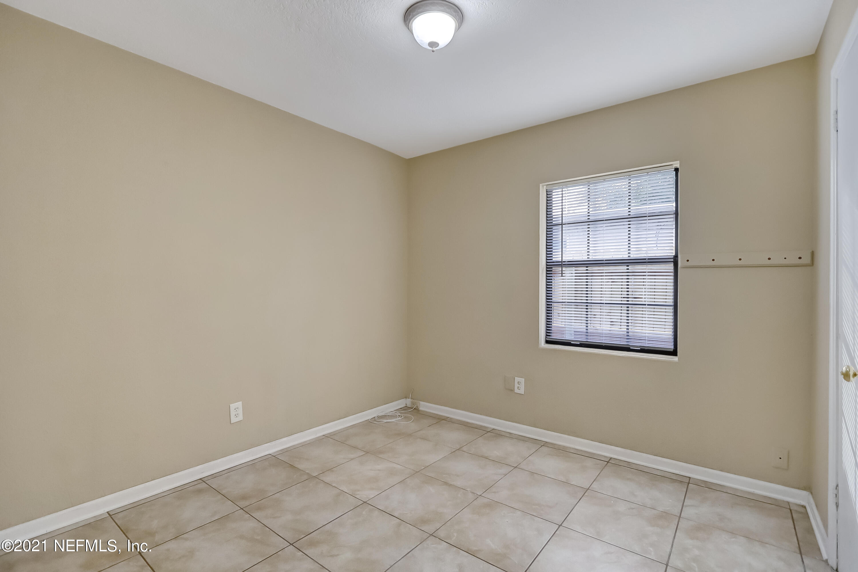 5207 Sunderland Road Jacksonville, FL 32210 - Photo 14 of 23 an empty room with windows and closet