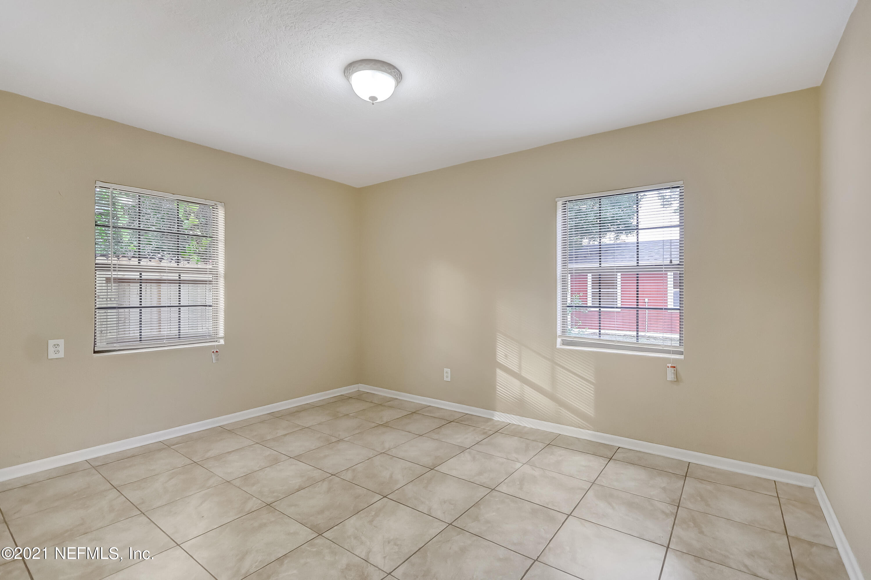 5207 Sunderland Road Jacksonville, FL 32210 - Photo 17 of 23 an empty room with windows