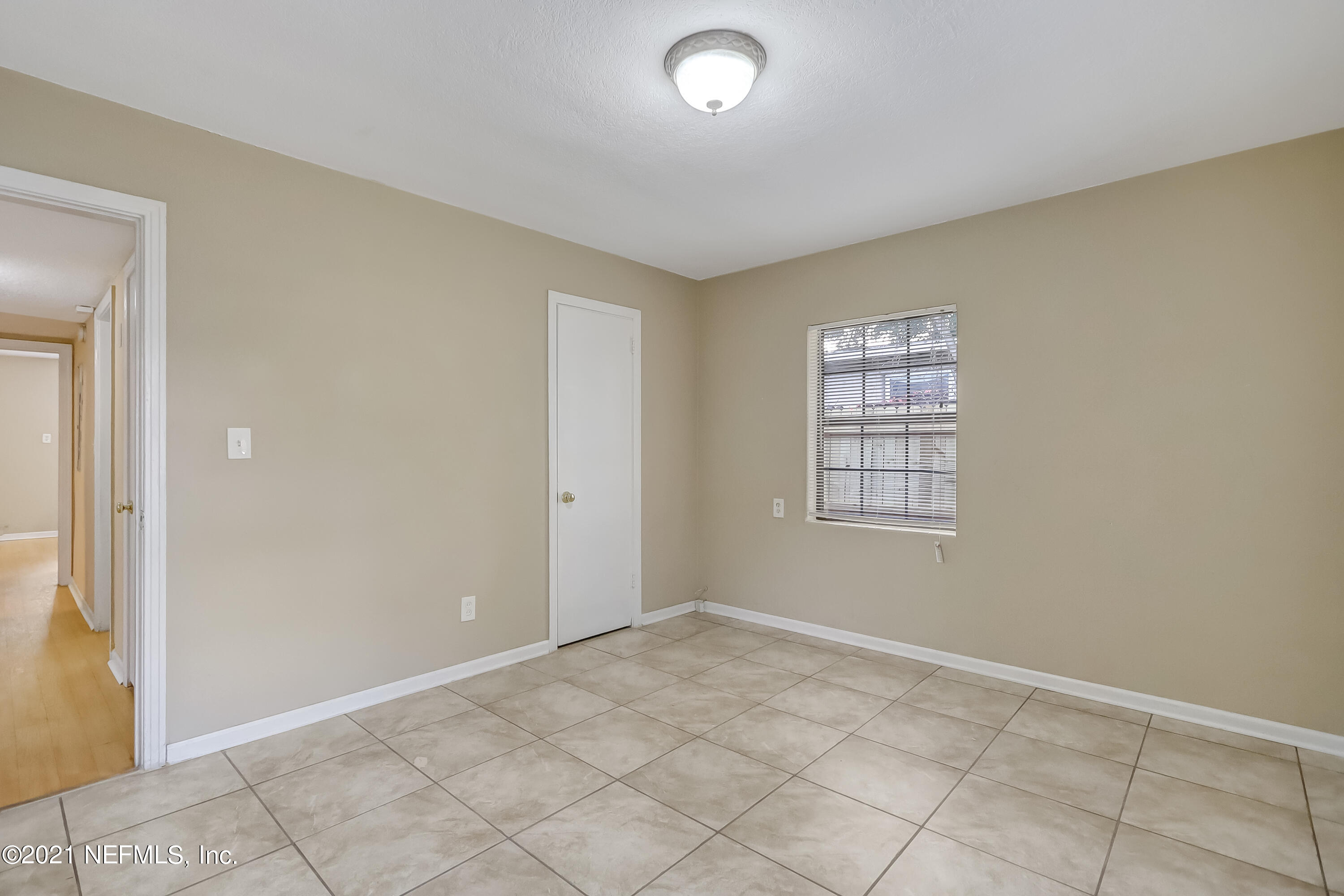 5207 Sunderland Road Jacksonville, FL 32210 - Photo 19 of 23 an empty room with windows