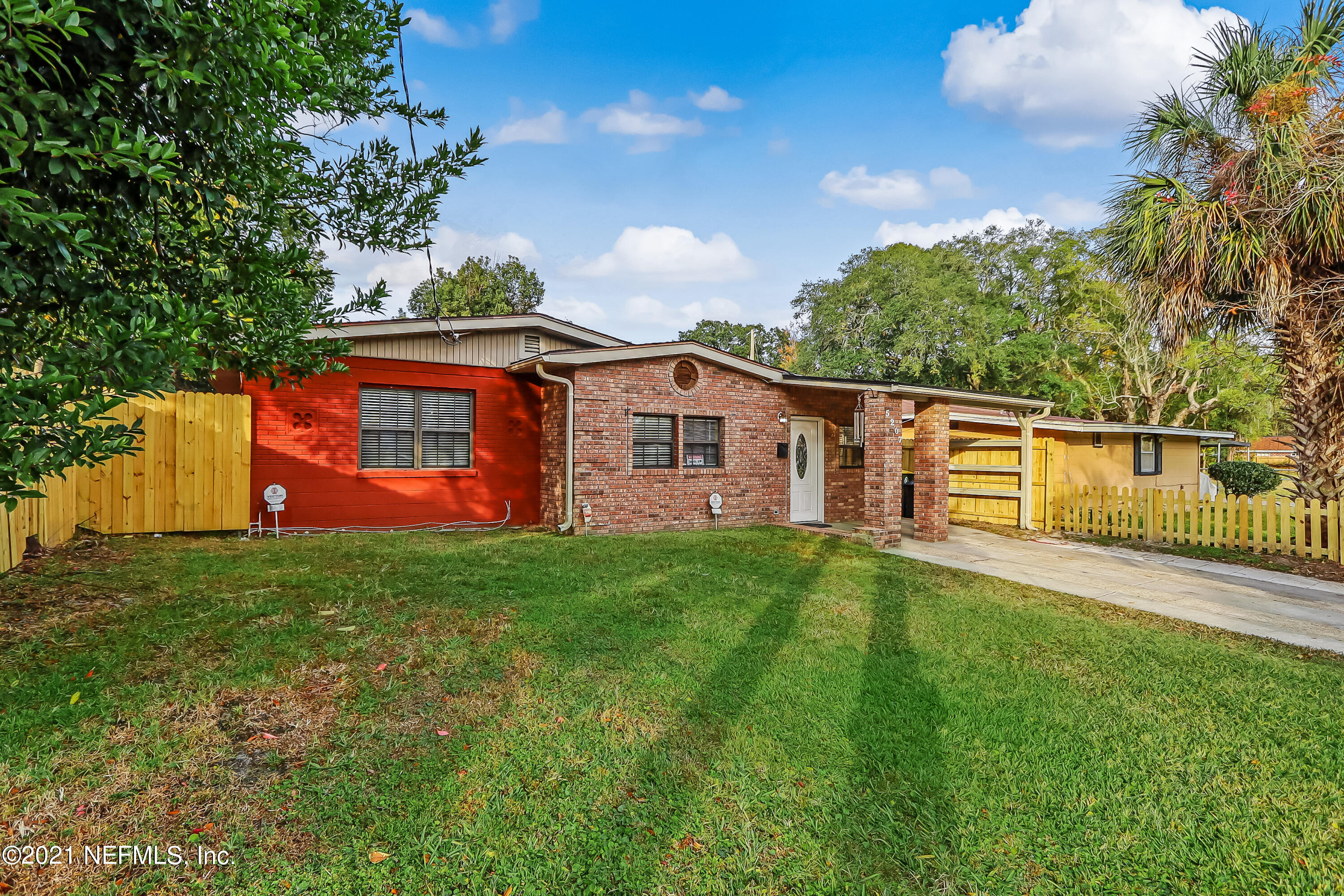 5207 Sunderland Road Jacksonville, FL 32210 - Photo 2 of 23 a view of a yard with a house in the background