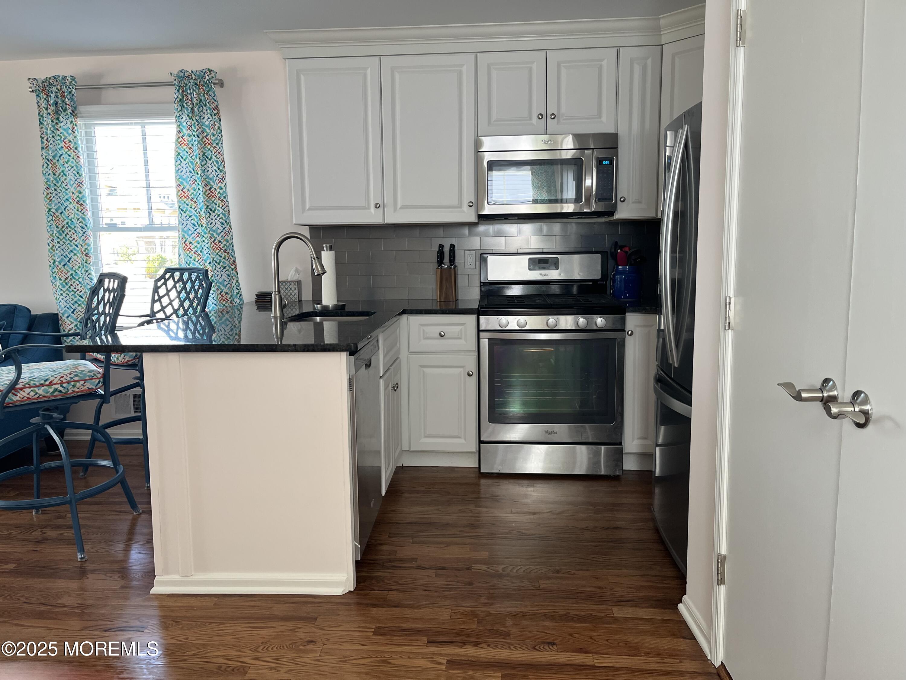 Undisclosed Address Bradley Beach, NJ 07720 - Photo 5 of 13 a kitchen with stainless steel appliances a stove a refrigerator and cabinets