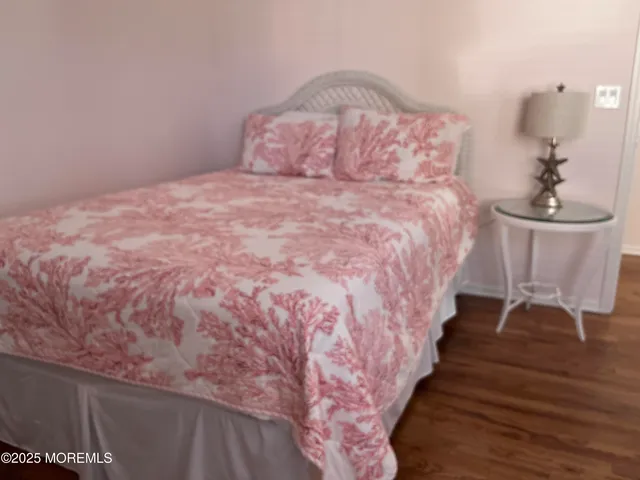 a large bed sitting in a bedroom next to a chandelier