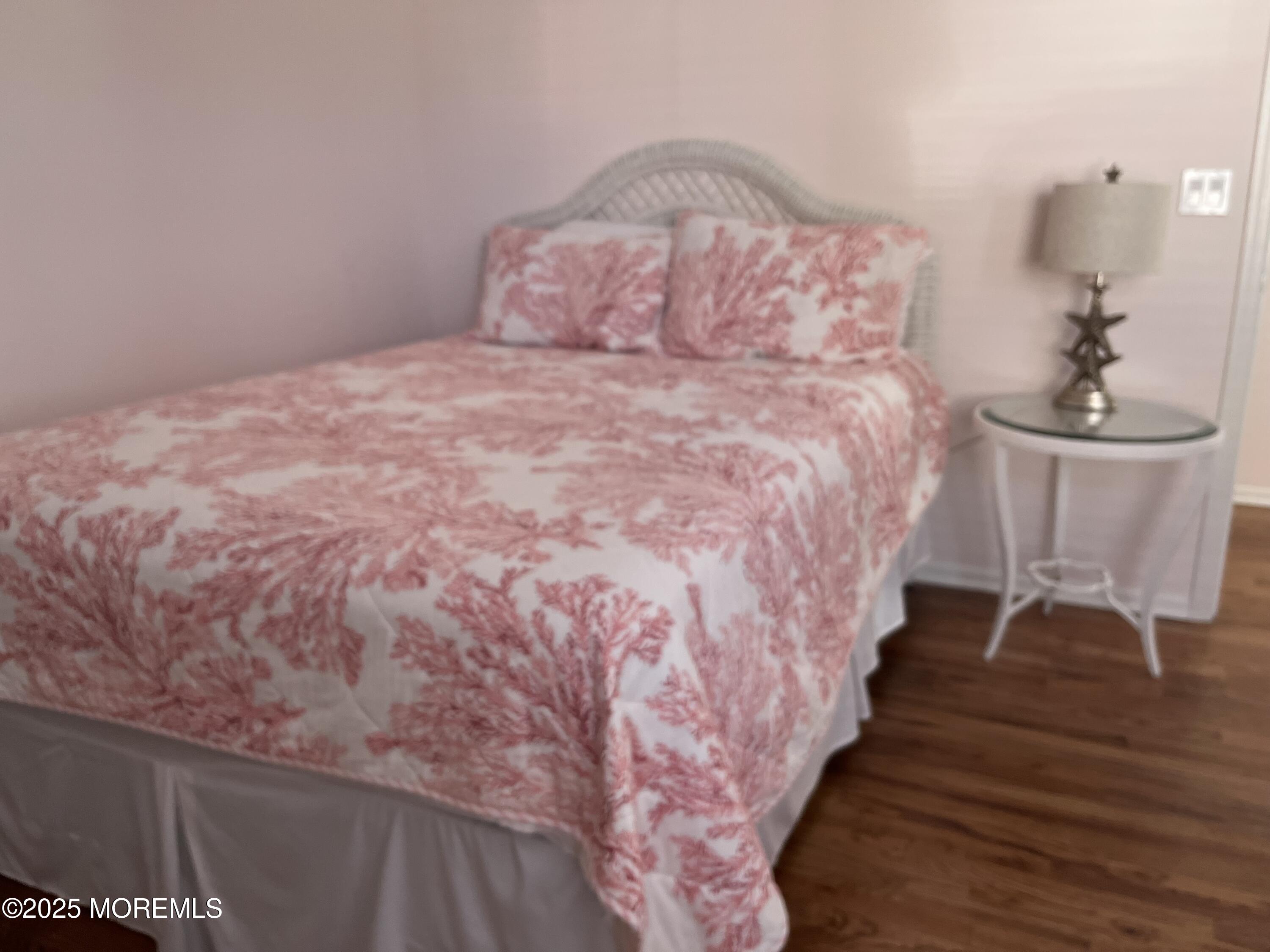 Undisclosed Address Bradley Beach, NJ 07720 - Photo 7 of 13 a large bed sitting in a bedroom next to a chandelier