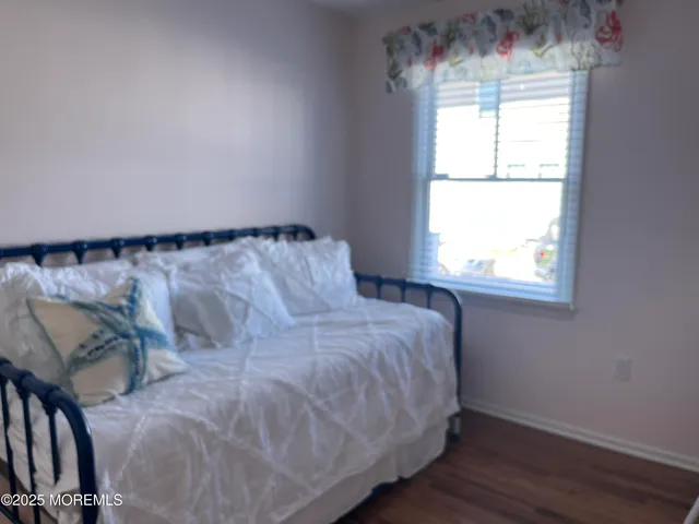a bed sitting in a bedroom next to a window