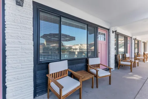 a roof deck with glass table and chairs