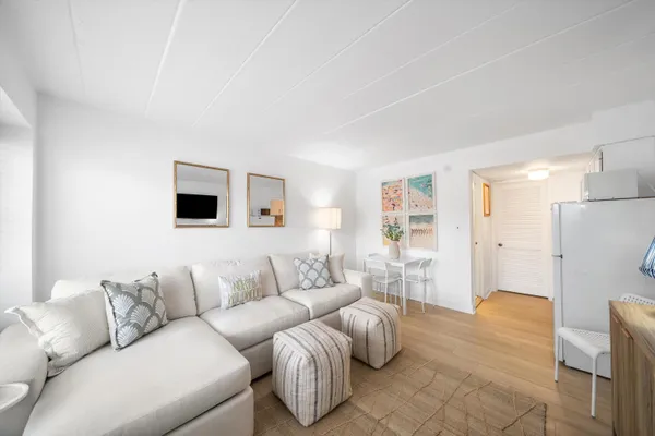 a spacious bedroom with two beds and a flat screen tv