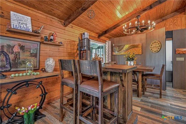 a view of a dining room with furniture and chandelier