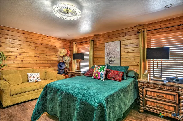 a bedroom with a bed and a chandelier