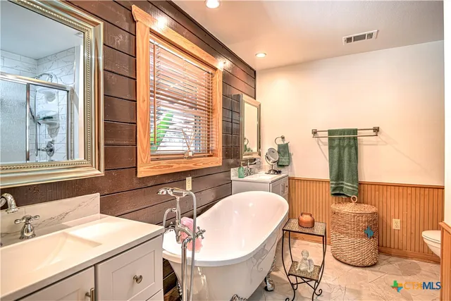 a bathroom with a sink double vanity and a mirror